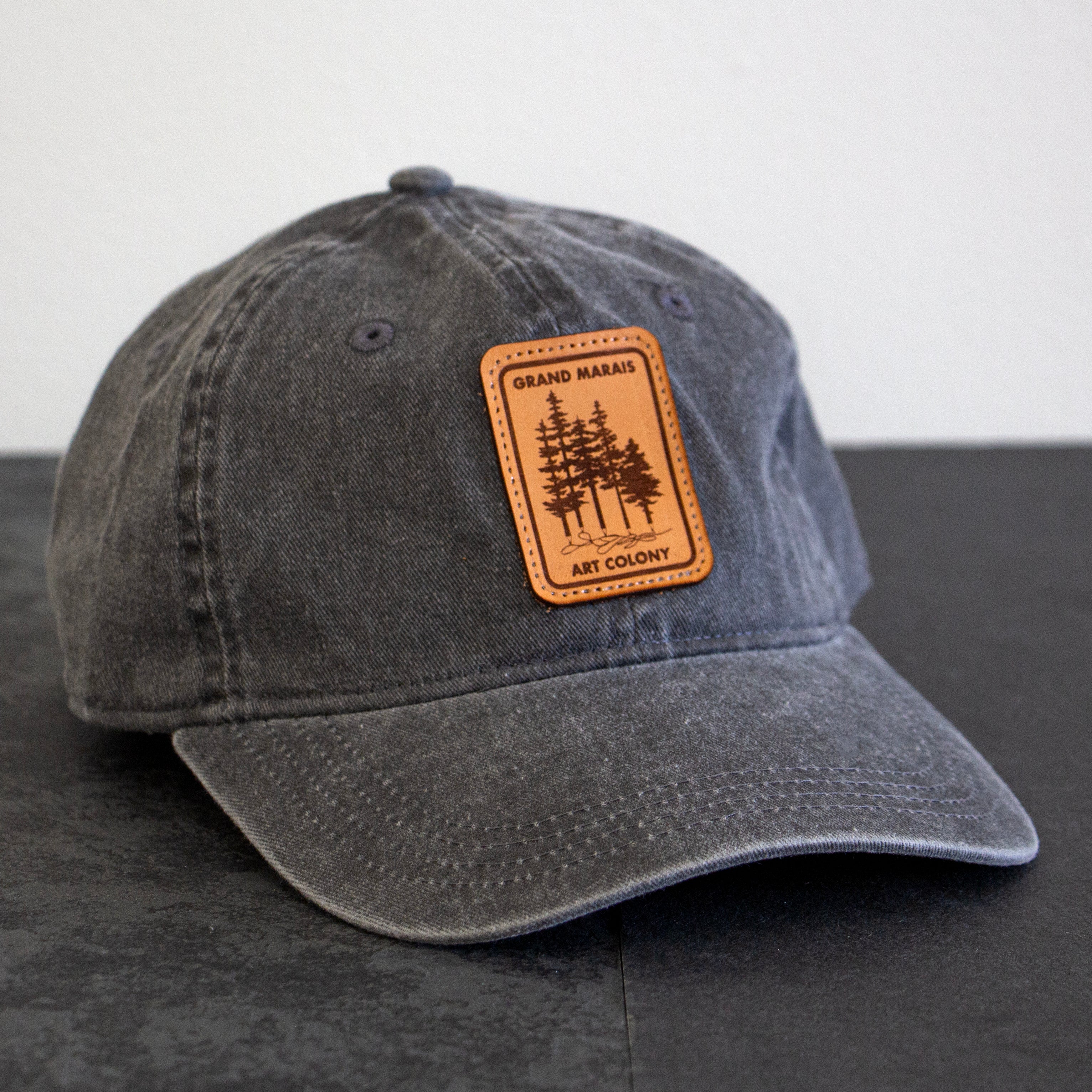 Charcoal cap with GMAC pine tree / pencil logo